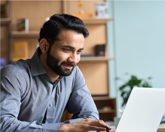 Man smiling looking at laptop 